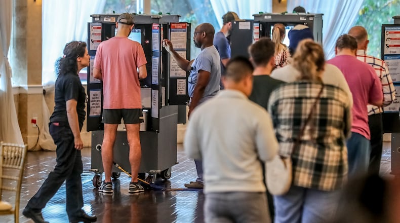 Voters casting their ballots on Tuesday at the Park Tavern in Atlanta. About 1.4 million voters showed up on Election Day, after 2.5 million cast ballots during three weeks of early voting. (John Spink / John.Spink@ajc.com)