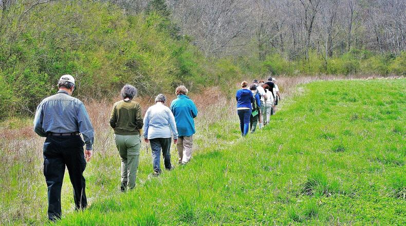 Georgia Botanical Society members and others stroll across a field in Walker County during an early spring botany walk. The society is one of several groups and state agencies that offer outings across Georgia throughout the year to observe and learn about nature. PHOTO CREDIT: Charles Seabrook