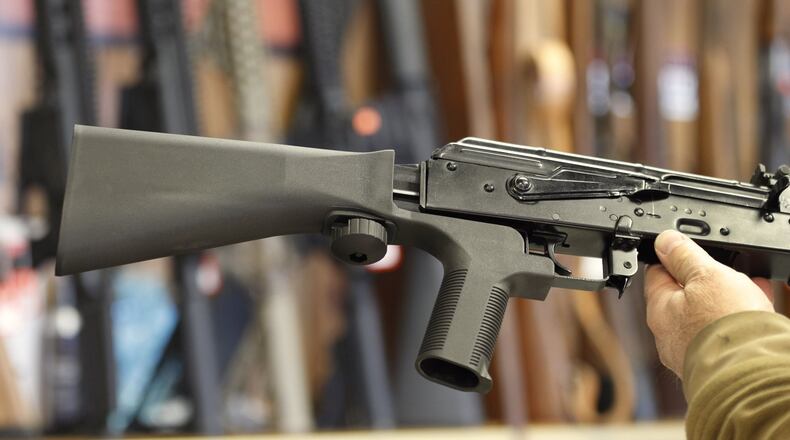 A bump stock, (left) that fits on a semiautomatic rifle to increase the firing speed, making it similar to a fully automatic rifle, is installed on an AK-47 at a gun store on October 5, 2017 in Salt Lake City, Utah. Congress is talking about banning this device after it was reported to have been used in the Las Vegas shootings on Oct. 1. (Photo by George Frey/Getty Images)