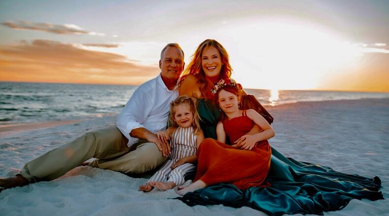 Former Georgia football coach Mark Richt and his wife, Katharyn, pose on Miramar Beach in Florida with their grandchildren, Zoe (L) and Jadyn, children of Jon and Anna Richt. (Photo contributed by Mark Richt)