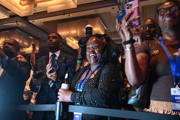 Supporters celebrate  after gubernatorial candidate Keisha Lance Bottoms waves wins the democratic primary election at her Election Day watch party at the Hyatt Regency on Tuesday, May 19, 2026, in Atlanta. (Natrice Miller for The AJC)