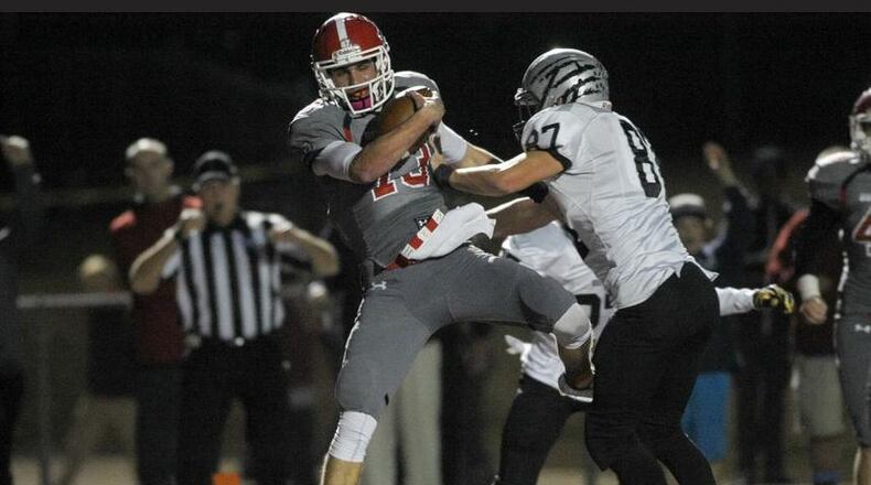 Acworth, Ga. -- Altoona senior quarterback Brandon Rainey (13) stumbles into the end zone for a touch down in the first half of play as Houston County senior defensive end Salomon Raas (87) defends in the third round of football playoffs Friday, November 27, 2015. SPECIAL/DANIEL VARNADO