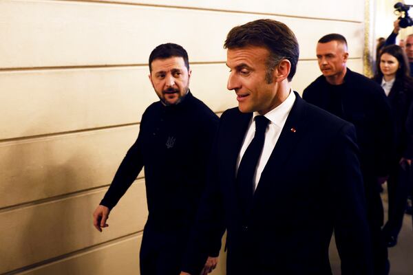Ukrainian President Volodymyr Zelenskyy, left, and French President Emmanuel Macron leave a joint press conference at the Elysee Palace in Paris, Wednesday, March 26, 2025. (Yoan Valat, Pool via AP)