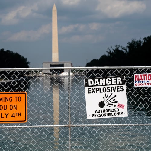 Signage and security fencing warns of explosives along the Lincoln Memorial Reflecting Pool ahead of July 4th events on the National Mall, Wednesday, July 1, 2026, in Washington. (AP Photo/Nathan Howard)
