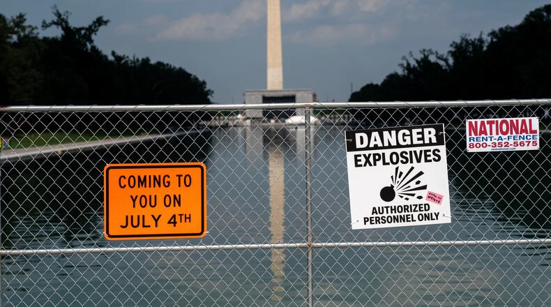 Signage and security fencing warns of explosives along the Lincoln Memorial Reflecting Pool ahead of July 4th events on the National Mall, Wednesday, July 1, 2026, in Washington. (AP Photo/Nathan Howard)