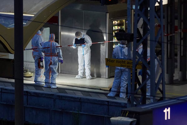 Investigators work at Hamburg, Germany's Central Station on Friday, May 23, 2025, after several people were injured in a knife attack. (Georg Wendt/dpa via AP)