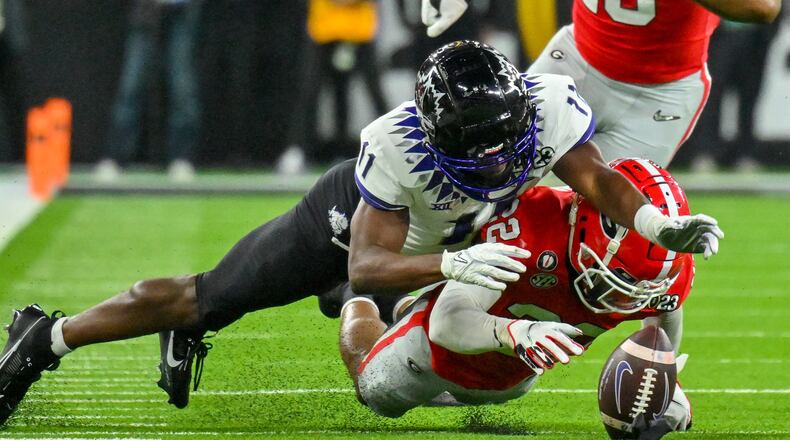 TCU Horned Frogs wide receiver Derius Davis (11) fumbles to Georgia Bulldogs’ Javon Bullard (22) during the first half of the College Football Playoff National Championship at SoFi Stadium in Los Angeles on Monday, January 9, 2023. (Hyosub Shin / Hyosub.Shin@ajc.com)