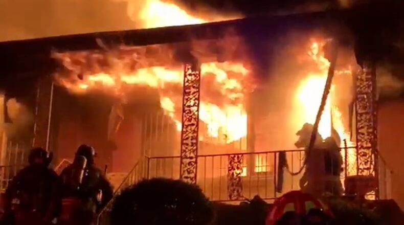 Atlanta Fire Capt. Danny Dwyer kneels on the porch after pulling 95-year-old Sallie Skrine from her home. From an Atlanta fire union video