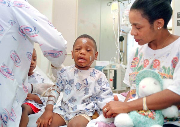 FILE - Davetta Green comforts her son, James Green, as a nurse removes an I.V. at Presbyterian Hospital in Oklahoma City on April 20, 1995. James was injured when he and his mother were in the YMCA building across the street from the Alfred P. Murrah Federal Building when it was bombed. (AP Photo, File)