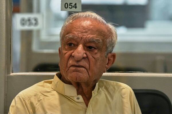 A dejected investor waits to restart trading, which suspended for an hour following a 5% drop in in its main index at the Pakistan Stock Exchange (PSE), in Karachi, Pakistan, Monday, April 7, 2025. (AP Photo/Fareed Khan)
