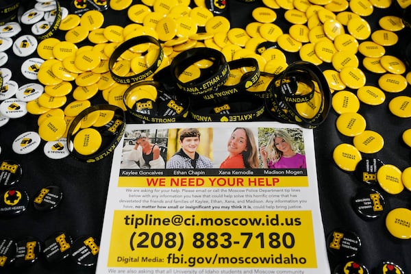 FILE - A flyer seeking information about the killings of four University of Idaho students who were found dead is displayed on a table along with buttons and bracelets on Nov. 30, 2022, during a vigil in memory of the victims in Moscow, Idaho. (AP Photo/Ted S. Warren, File)