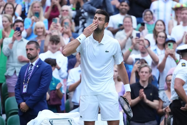 Novak Djokovic of Serbia blows a kiss as he celebrates beating Miomir Kecmanovic of Serbia during a third round men's singles match at the Wimbledon Tennis Championships in London, Saturday, July 5, 2025. (AP Photo/Kirsty Wigglesworth)