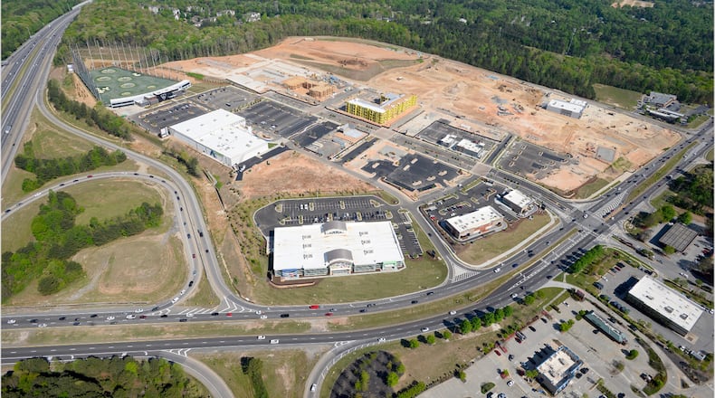 The Exchange at Gwinnett, a 106-acre mixed-use development near the Mall of Georgia, will have about 75 businesses and 1,000 residential apartments. The Rooms To Go, the largest one in the Southeast, can be seen from Buford Drive. Top Golf and its high net can be seen from I-85. (Courtesy of Fuqua Development)