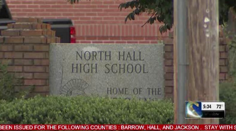 A high school crossing guard is recovering after being hit by a car because a driver was on his cellphone, authorities said.