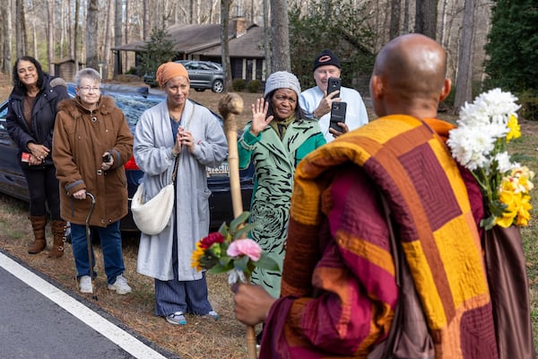 People greet the monks in Fayetteville on Dec. 29. 