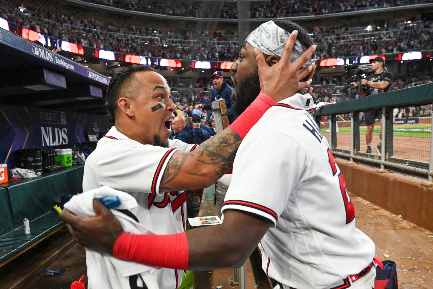 Atlanta Braves’ Orlando Arcia (11) and Michael Harris II (23) celebrate after Austin Riley’s two-run home run against the Philadelphia Phillies during the eighth inning of NLDS Game 2 in Atlanta on Monday, Oct. 9, 2023.   (Hyosub Shin / Hyosub.Shin@ajc.com)