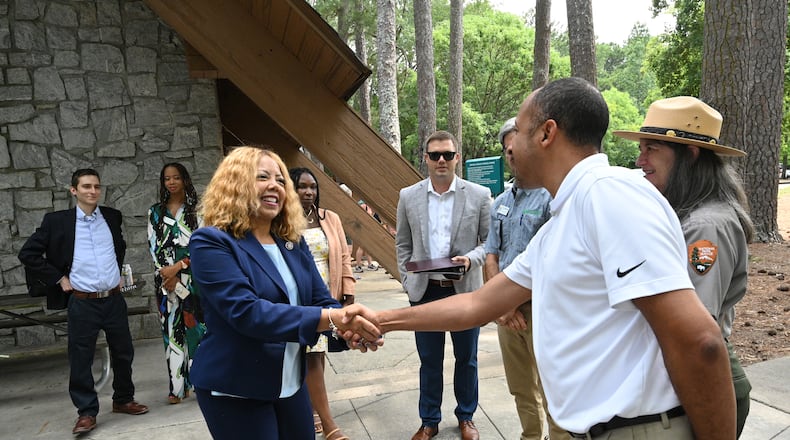 U.S. Rep. Lucy McBath (left) is greeted by a guest as she arrives for an event that intended to educate members of the public about implementation of the Chattahoochee River Act at Jones Bridge Park, Thursday, August 3, 2023, in Peachtree Corners. The Chattahoochee River Act was sponsored by Rep. Lucy McBath and Sen. Jon Ossoff in the House and Senate. (Hyosub Shin / Hyosub.Shin@ajc.com)