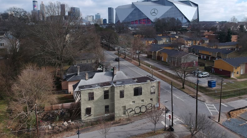 Aerial view of neighborhoods west of downtown Atlanta in the foreground and Mercedes-Benz Stadium in the background on Thursday, January 24, 2019. HYOSUB SHIN / HSHIN@AJC.COM