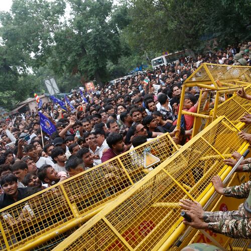 Supporters of the Cockroach Janta Party push against a barricade as they attempt to march to India's Parliament, demanding the resignation of the education minister, in New Delhi, Monday, July 20, 2026. (AP Photo/Shekhar Yadav)