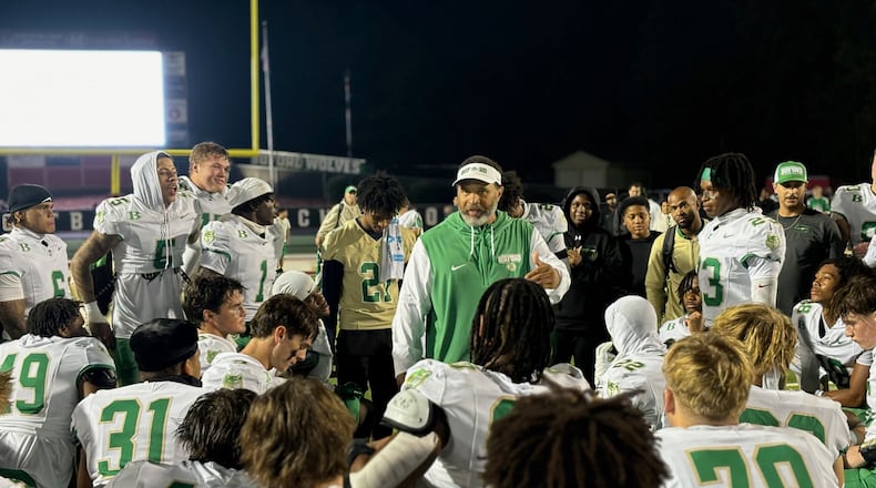 Buford coach Bryant Appling talks to his team after their 32-7 win over Mill Creek on Nov. 1, 2024, that gave the Wolves the region championship.