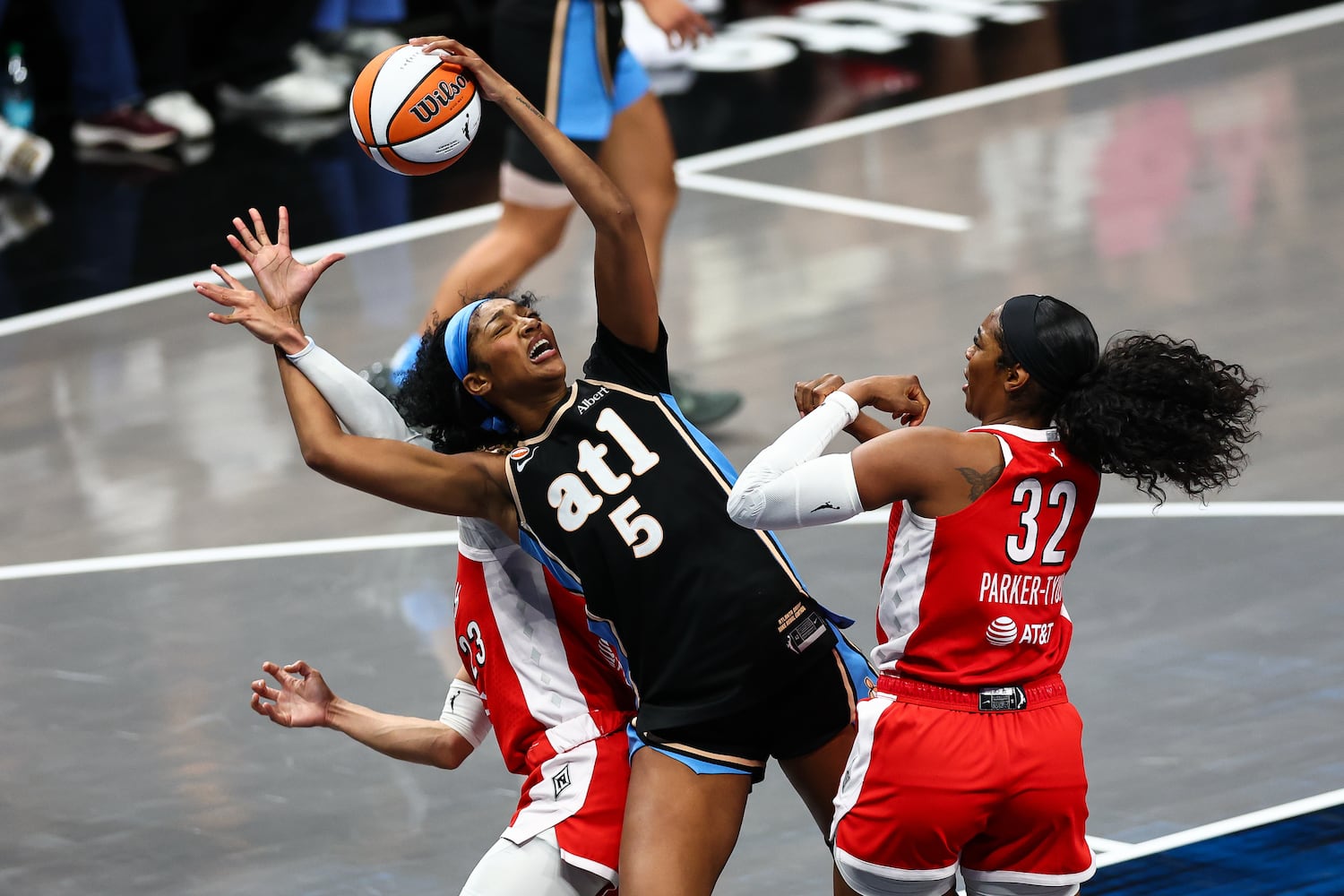 Atlanta Dream forward Angel Reese (5) fights for a rebound against Las Vegas Aces guard Chennedy Carter, left, and Las Vegas Aces forward Cheyenne Parker-Tyus (32) during the second half of a WNBA game at State Farm Arena on Sunday, May 17, 2026, in Atlanta. (Colin Hubbard for the AJC) 