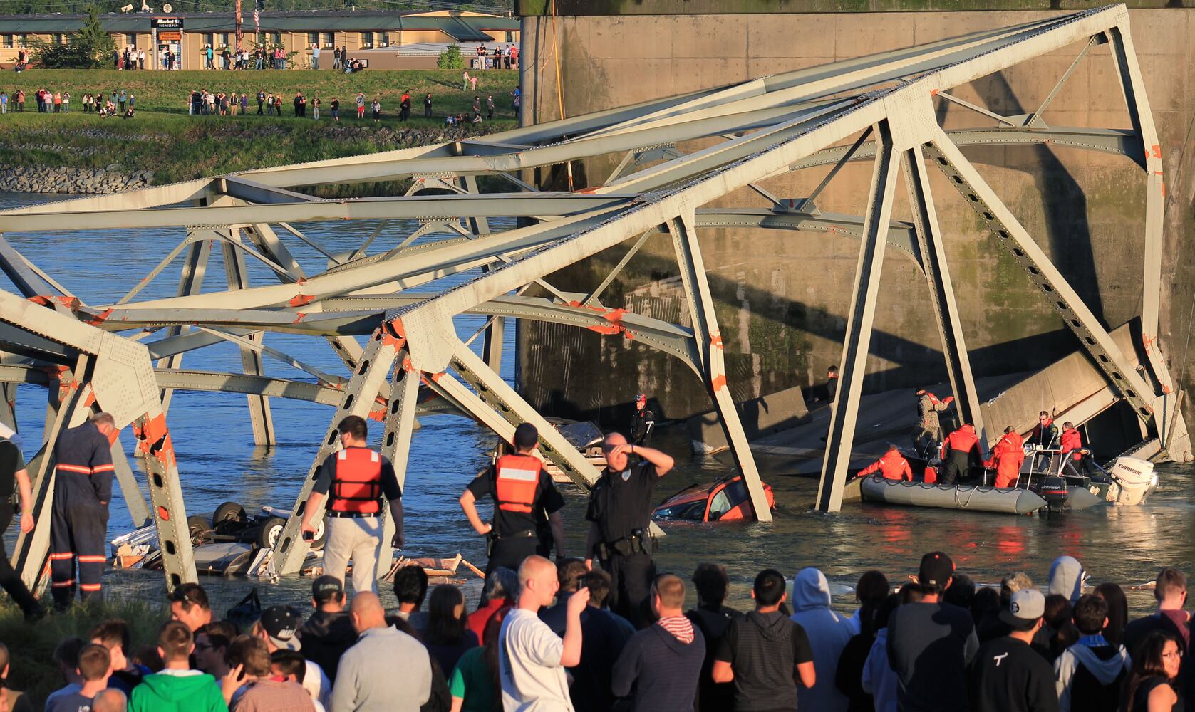 Vehicles, people dumped into water