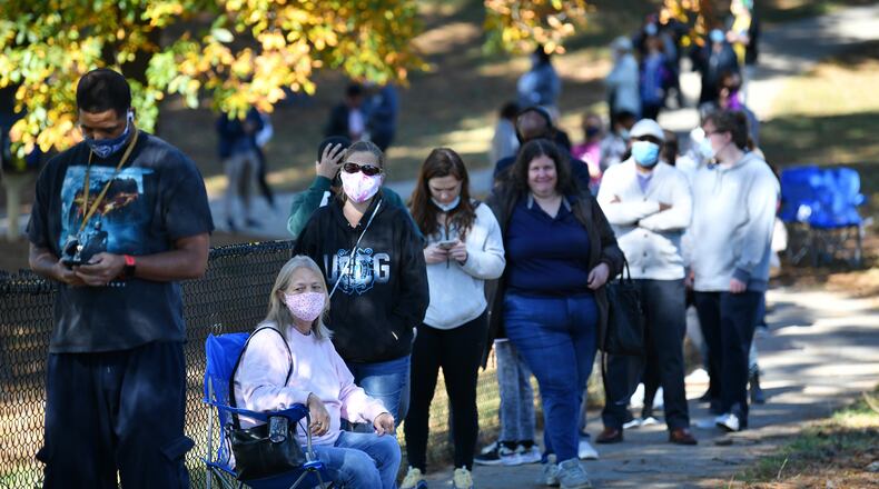 Deborah Wood sitting on a camping chair waits in lines to cast a ballot at the Shorty Howell Park Activity Building in Duluth, Georgia on the last day of early voting on Friday, Oct. 30, 2020. (Hyosub Shin/Atlanta Journal-Constitution/TNS)