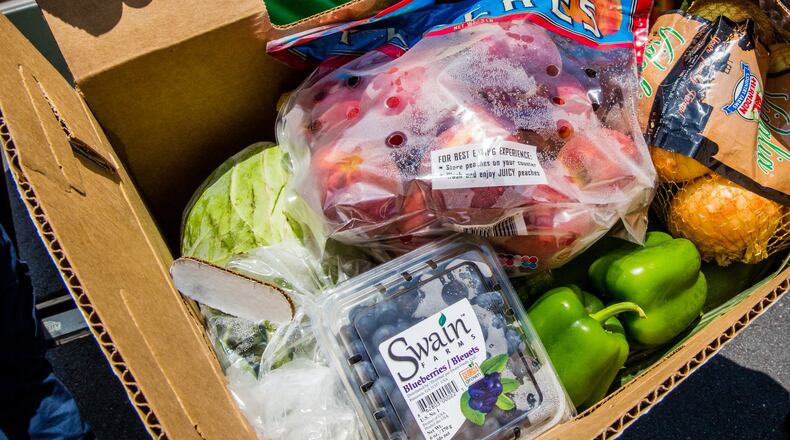 The boxes of produces included onions, peaches, blueberries, bell peppers, cabbage and more. (Jenni Girtman for Atlanta Journal Constitution)