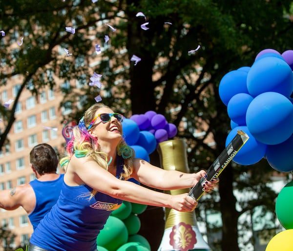 On The Bert Show Q99.7 float, Kristin Klingshirn spreads confetti during the Atlanta Pride Parade on Sunday, Oct. 9, 2022. (Jenni Girtman for the AJC)