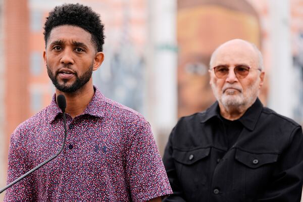 Baltimore Mayor Brandon Scott, left, accompanied by attorney William H. "Billy" Murphy, Jr., speaks at a memorial event commemorating the ten-year anniversary of the death of Freddie Gray, Saturday, April 19, 2025, in Baltimore. (AP Photo/Stephanie Scarbrough)