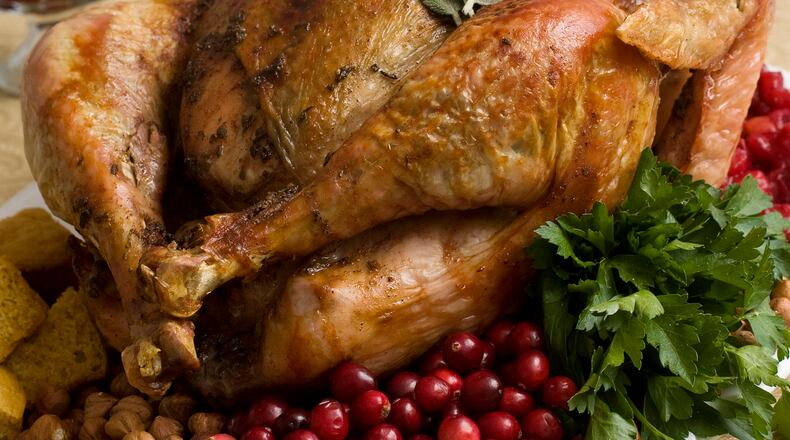 FILE - This Nov. 2, 2009, file photo shows a Thanksgiving turkey in Concord, N.H. Food safety experts say raw turkeys shouldnt be rinsed, since that can spread harmful bacteria. Cooking should kill any germs. But bacteria can still spread in other ways, so washing and sanitizing hands and surfaces is still important. (AP Photo/Larry Crowe, File)