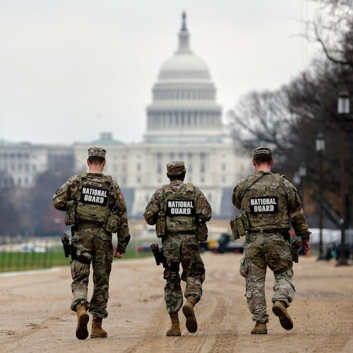 National Guard patrol along the National Mall in front of the Capitol, Wednesday, Nov. 26, 2025, in Washington. (AP Photo/Rahmat Gul)
