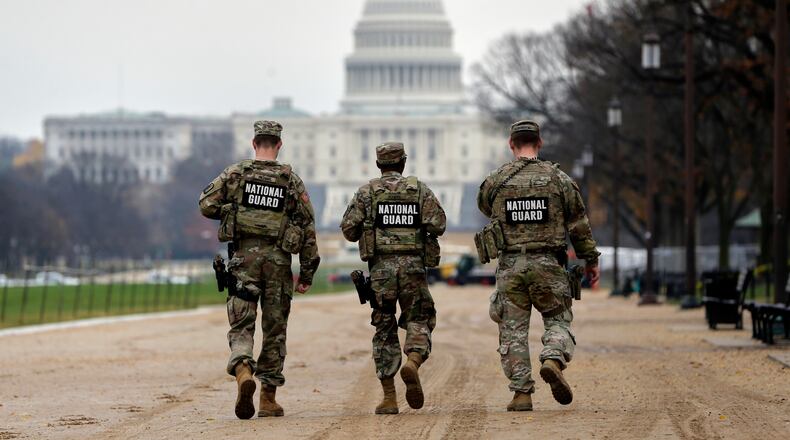 National Guard patrol along the National Mall in front of the Capitol, Wednesday, Nov. 26, 2025, in Washington. (AP Photo/Rahmat Gul)