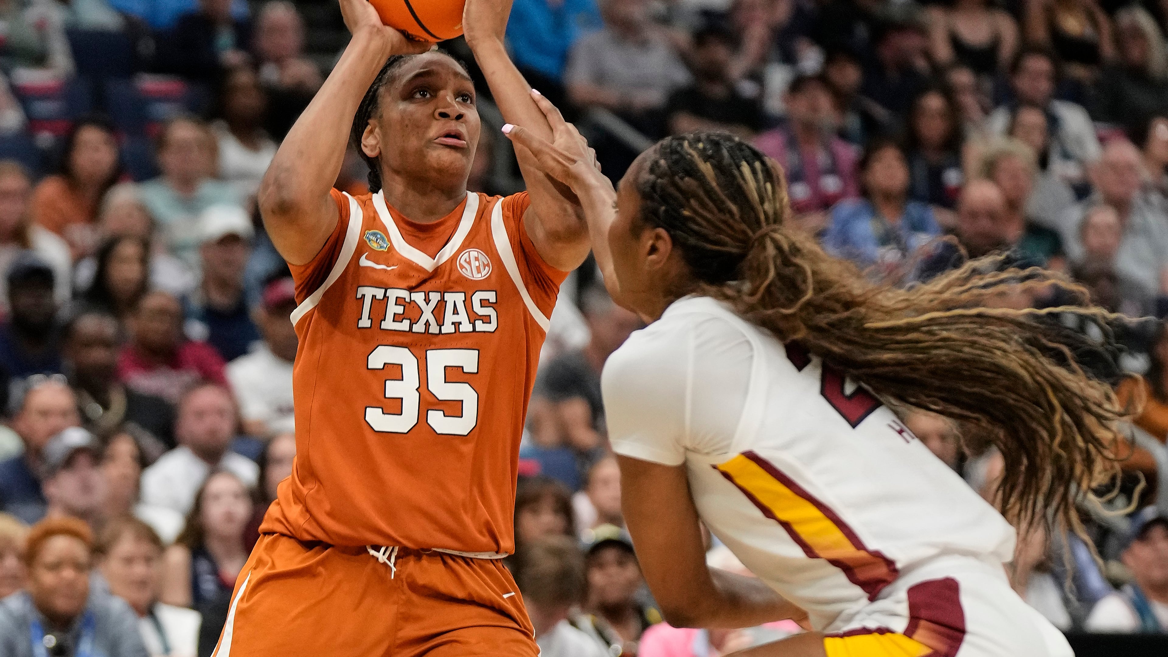 FILE - Texas forward Madison Booker (35) is fouled while shooting by South Carolina guard Bree Hall (23) during the first half of a national semifinal Final Four game during the women's NCAA college basketball tournament, on April 4, 2025, in Tampa, Fla. (AP Photo/Chris O'Meara, File)