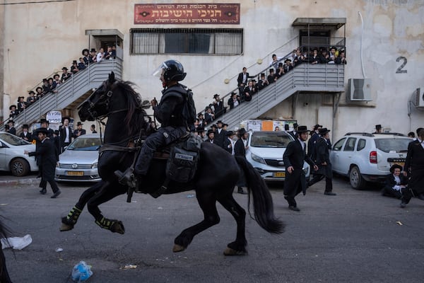 FILE - Israeli police officers scuffle with ultra-Orthodox Jewish men during a protest against a potential new draft law in Jerusalem, Oct. 31, 2024. (AP Photo/Ohad Zwigenberg, File)