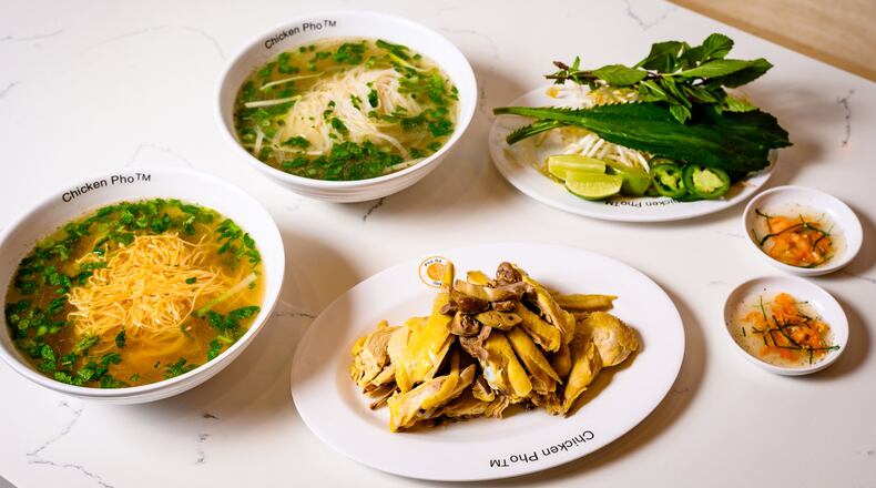 Diners at Pho Ga Tony Tony are served the components to make their pho ga. Here, a half chicken (enough for two people) is shown with egg noodles (left) and rice noodles (top), dipping sauce and a tray of bean sprouts, culantro, basil, sliced raw jalapenos and lime wedges. CONTRIBUTED BY HENRI HOLLIS