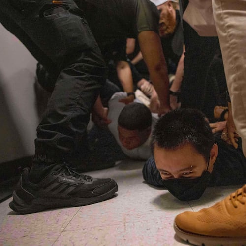 FILE - A Dominican man, left, and an activist, right, are detained by plainclothes officers with Immigration and Customs Enforcement after an immigration hearing at the immigration court inside the Jacob K. Javits Federal Building in New York, on June 6, 2025. (AP Photo/Yuki Iwamura, File)