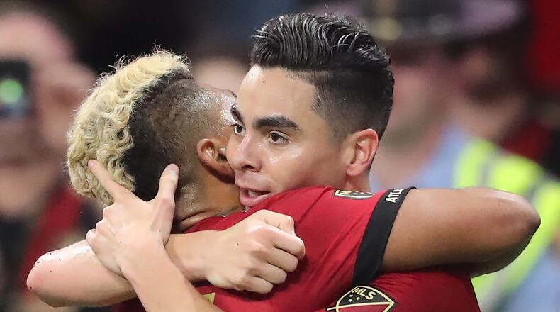 March 11, 2018 Atlanta: Atlanta United midfielder Miguel Almiron and forward Josef Martinez celebrate Almironâs goal against D.C. United for a 2-0 lead during the second half in a MLS soccer match on Sunday, March 11, 2018, in Atlanta. Martinez scored the first goal of the game on the way to a 3-1 victory in the home opener. Curtis Compton/ccompton@ajc.com