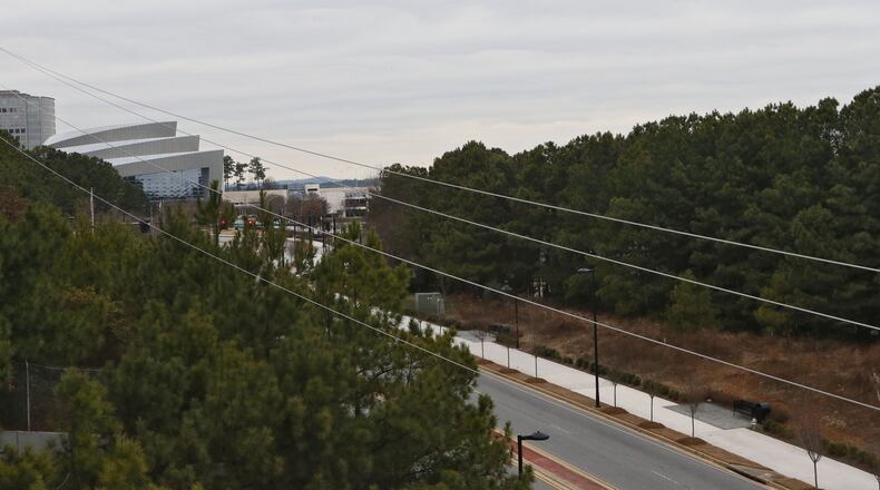The property is at right, bordered by Cobb Galleria Parkway (in front). The Cobb Energy Center is visible at left. A proposed $100 million condo/office project in Cobb County has turned an otherwise routine bond approval by the local development authority into a battlefront over tax incentives and their cost to the school system. The project was delayed a month while the authority worked out differences with school board over lost tax revenue. BOB ANDRES / BANDRES@AJC.COM