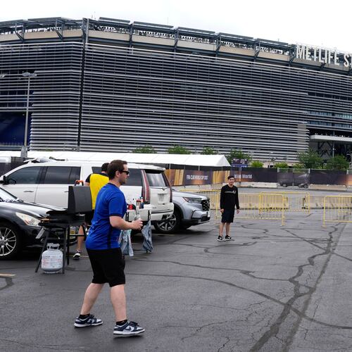 FILE - Fans play with a ball outside the Metlife Stadium prior to the Club World Cup final soccer match between Chelsea and PSG in East Rutherford, N.J., Sunday, July 13, 2025. (AP Photo/Pamela Smith, File)