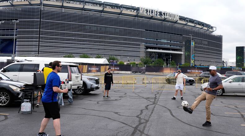 FILE - Fans play with a ball outside the Metlife Stadium prior to the Club World Cup final soccer match between Chelsea and PSG in East Rutherford, N.J., Sunday, July 13, 2025. (AP Photo/Pamela Smith, File)