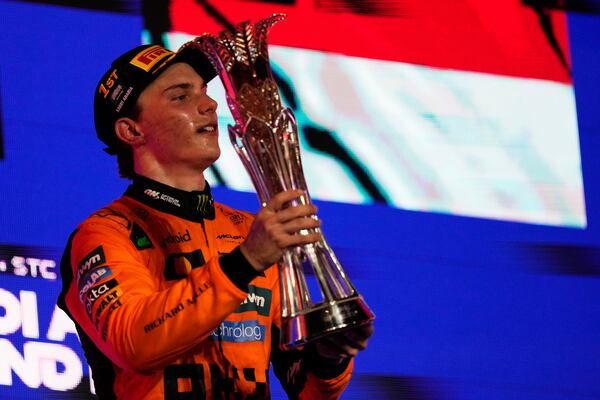 McLaren driver Oscar Piastri of Australia celebrates on the podium after winning the Formula One Saudi Arabian Grand Prix at the Jeddah Corniche Circuit in Jeddah, Saudi Arabia, Sunday, April 20, 2025. (AP Photo/Darko Bandic)