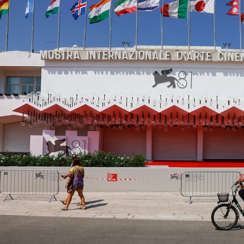 FILE - Festival goers pass the red carpet of the 81st edition of the Venice Film Festival in Venice, Italy, Aug. 27, 2024. (Photo by Vianney Le Caer/Invision/AP, File)