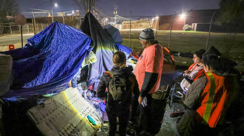 Todd Rick, 31, who is homeless, emerges from an encampment as Jose Sandoval, the director of homeless at Frontline Response Atlanta, center right, and volunteers participate in the PIT, (Point-In-Time) count near the Mechanicsville neighborhood, Monday, Jan. 23, 2023, in Atlanta. The group of volunteers and staff from supporting agencies where participating in the PIT count, a practice mandated by the federal government that tallies people who were homeless on one night in January of each year. Jason Getz / Jason.Getz@ajc.com)