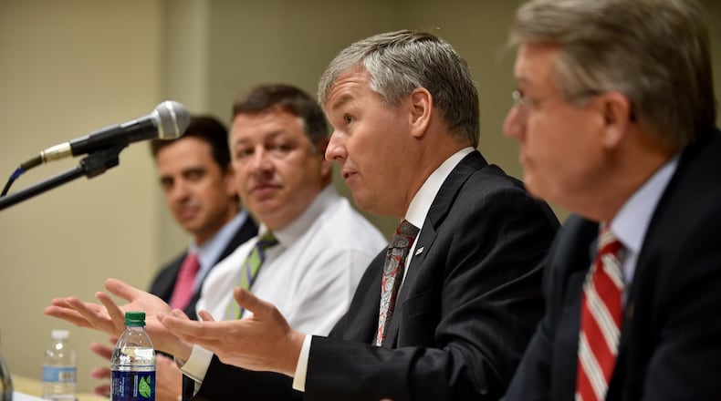 U.S. Rep. Tom Graves, R-Ga.; House Transportation and Infrastructure Committee Chairman Bill Shuster, R-Pa.; U.S. Rep. Rob Woodall, R-Ga. (speaking); and U.S. Rep. Rick Allen, R-Ga., participate Tuesday in a roundtable discussion about federal transportation funding with leaders from Coca-Cola, UPS, the Georgia Port Authority and the Georgia Department of Transportation. The event was hosted by Georgia Tech. BRANT SANDERLIN/BSANDERLIN@AJC.COM