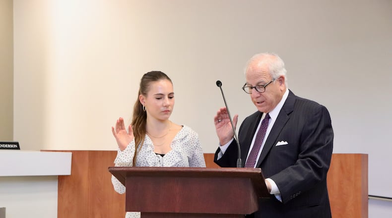 Decatur High senior Sophie D'Elena was sworn onto the City Schools of Decatur's board of education by board attorney Bob Wilson. Courtesy