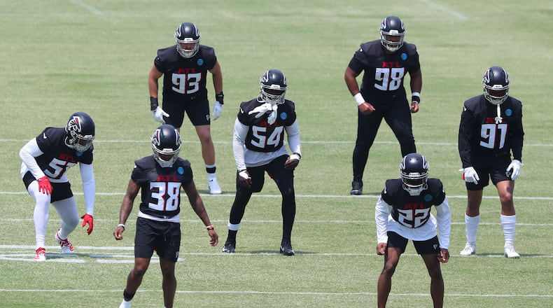 Eli Ankou (98) with several Falcons defenders during OTAs at the team training facility on Tuesday, May 25, 2021, in Flowery Branch. (Curtis Compton/AJC file photo)