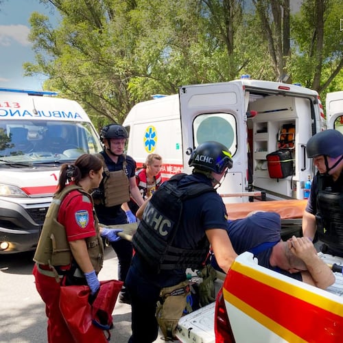 In this photo provided by the Ukrainian Emergency Services on Monday, June 29, 2026, a rescue worker with paramedics move an injured man into an ambulance after a Russian drone strike on passengers minivan in Dnipropetrovsk region, Ukraine. (Ukrainian Emergency Service via AP)