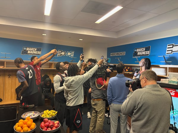 Georgia center Somto Cyril (far right) is the center of attention during an open locker-room session before the Bulldogs' NCAA Tournament game March 18, 2026 at KeyBank Center in Buffalo, N.Y. (AJC photo by Ken Sugiura)