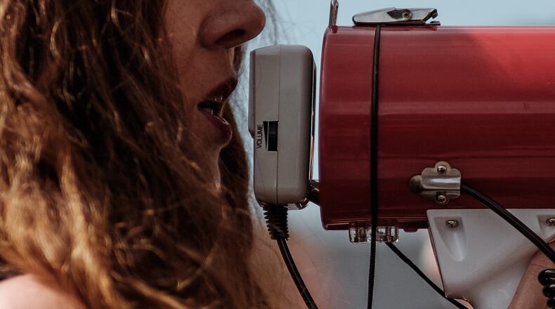 A woman was arrested at a Valdosta protest for an obscene sign (not pictured).